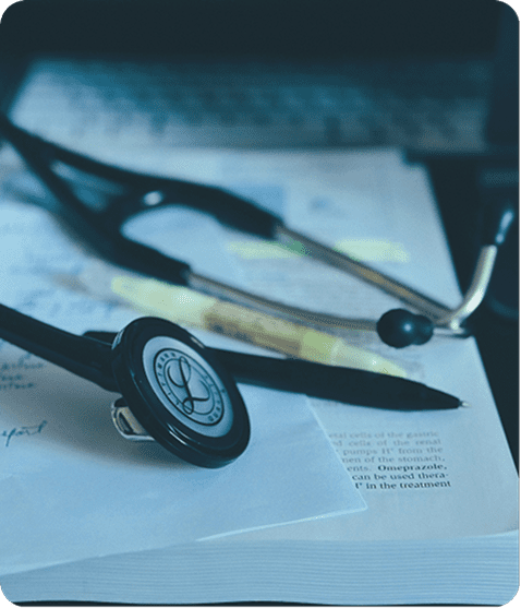 Stethoscope and pen on medical documents.