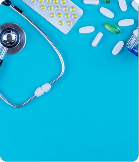 Stethoscope and pills on blue background.